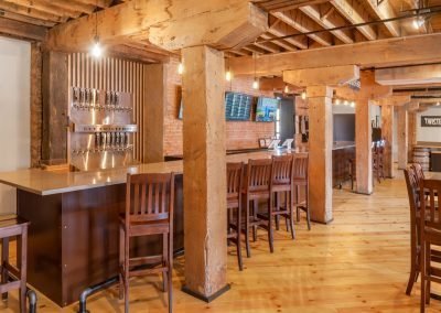 Twisted Vine Brewery seating bar area with hardwood floor