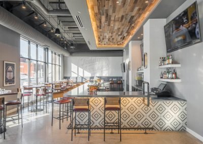 Teddy Maroon's side view of bar, hardwood structures, and high chairs