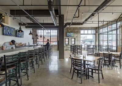 Walnut restaurant seating area with bar side view